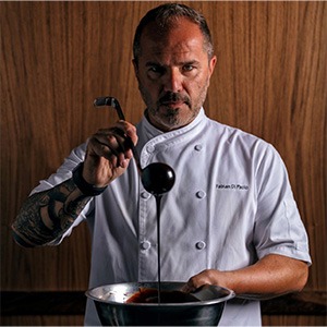 fabian di paolo preparing food, wearing a white chef shirt