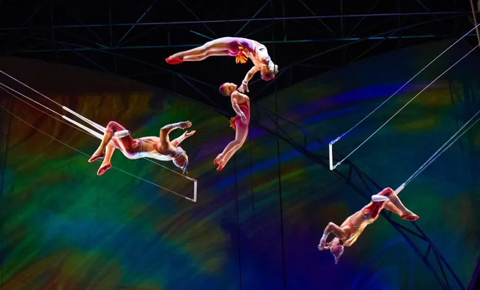three trapeze artists performing at Mystere Cirque du Soleil