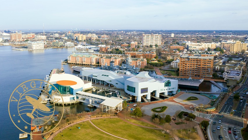 aerial view of Elizabeth River harbor and Town Point Park in the Water District of Norfolk overlayed with brown "virginia" stamp