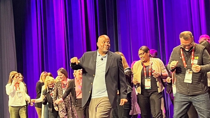 andre norman dancing on stage with people at site