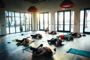 women in room doing yoga