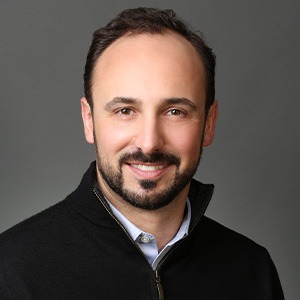 anthony fantaroni wearing black jacket and blue dress shirt