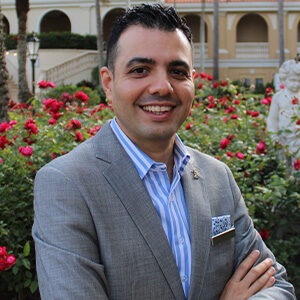 Bayan Sabermanesh wearing vertically lined blue and white dress shirt and grey sport coat