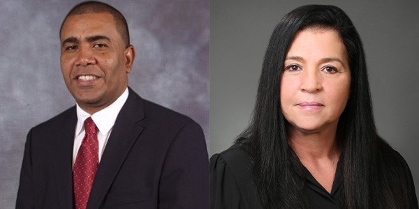 Cletus Pancham on left wearing white dress shirt, red tie and black sport coat, and Jennifer Simmons on right wearing black dress shirt