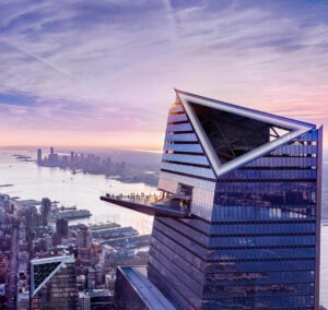 Arial view of 30 Hudson Yards with dusk scene of New York City in background