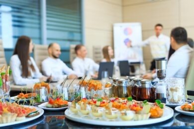 A table with canapes and various snacks served on the background of a business meeting