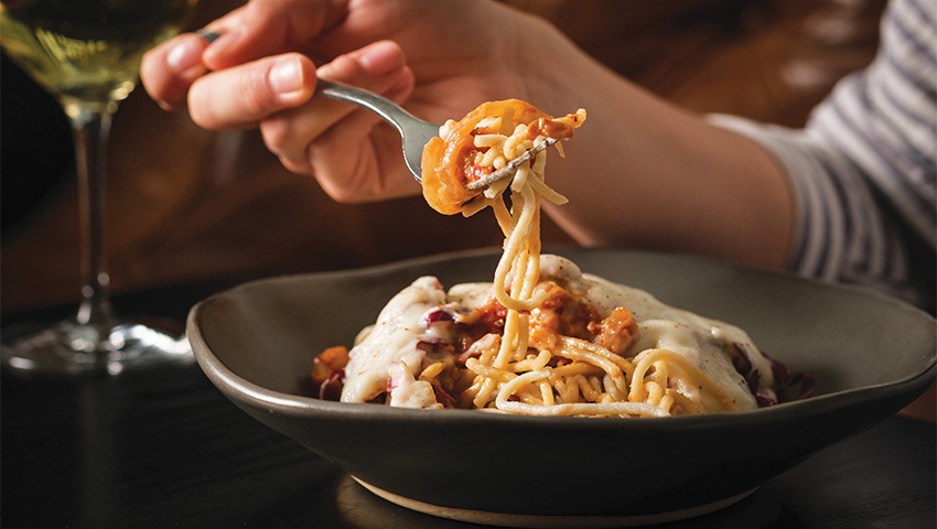 close up shot of person eating spaghetti