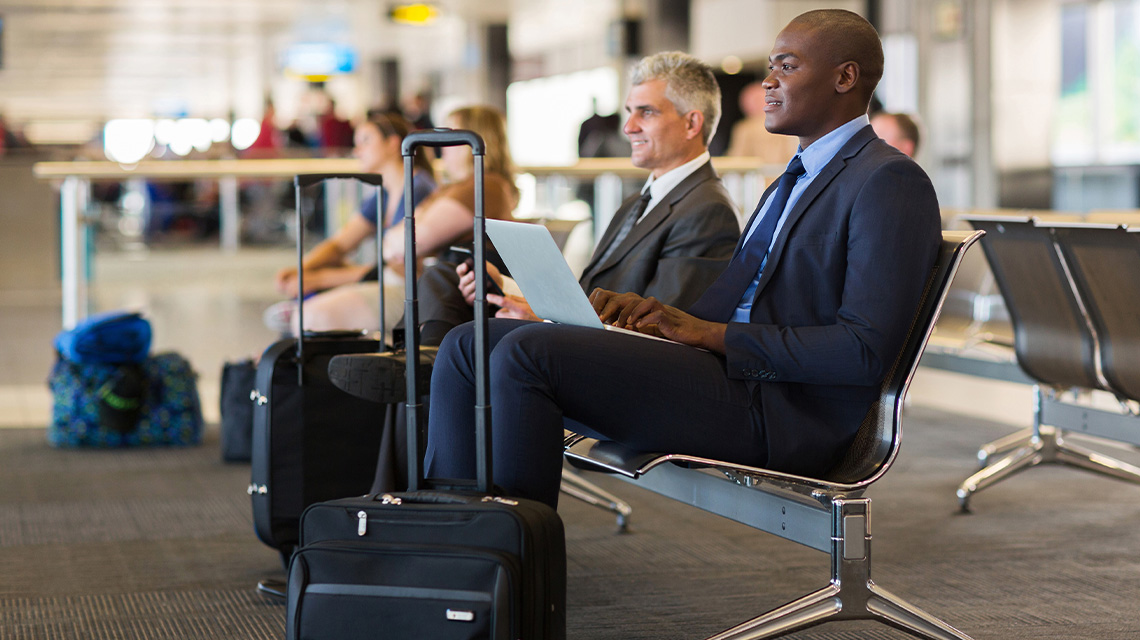 two businesspeople waiting at airport