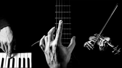 black and white image of three hands playing different musical instruments