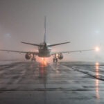 runway foggy night, view of the plane from the tail