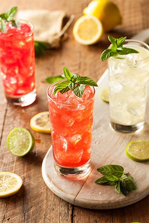 three cocktails sitting on table