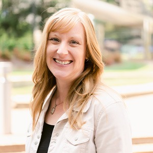 woman wearing cream jacket and black shirt