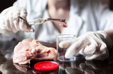 person placing meat in glass receptacle