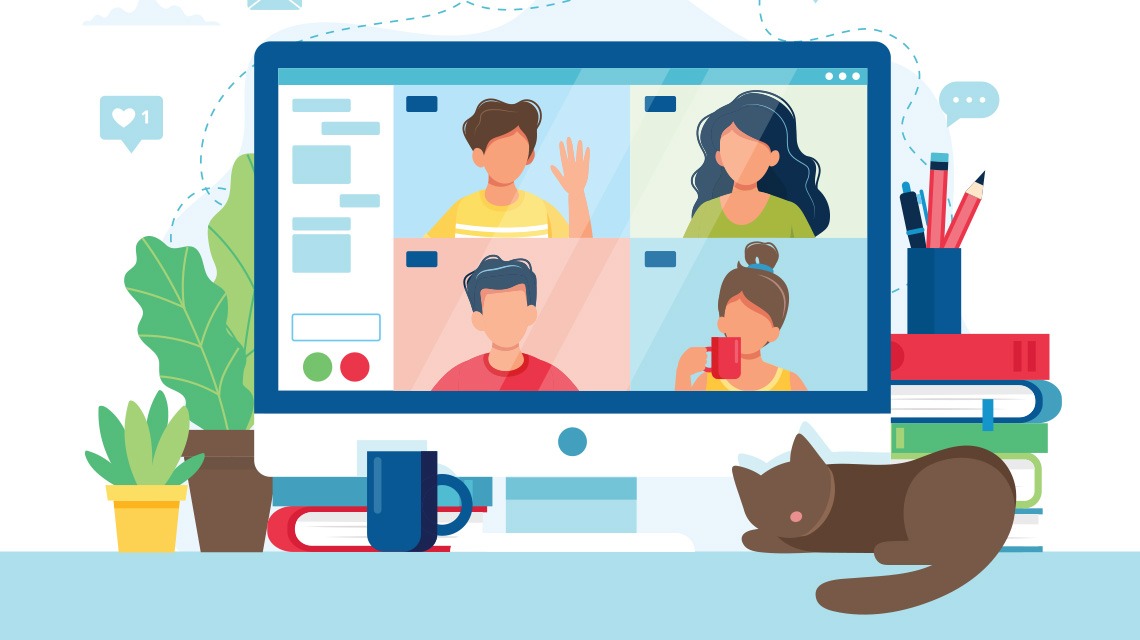 A computer screen shows four people on a virtual meeting. On the desk, there are plants, a mug, an da cat.
