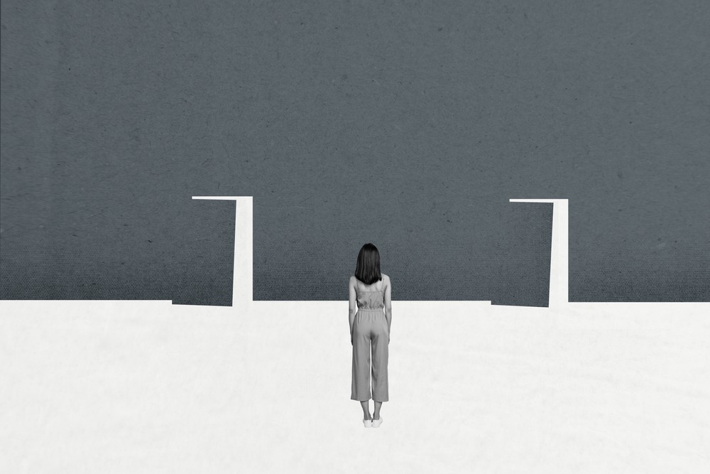 grey illustration of woman standing in front of two open doors
