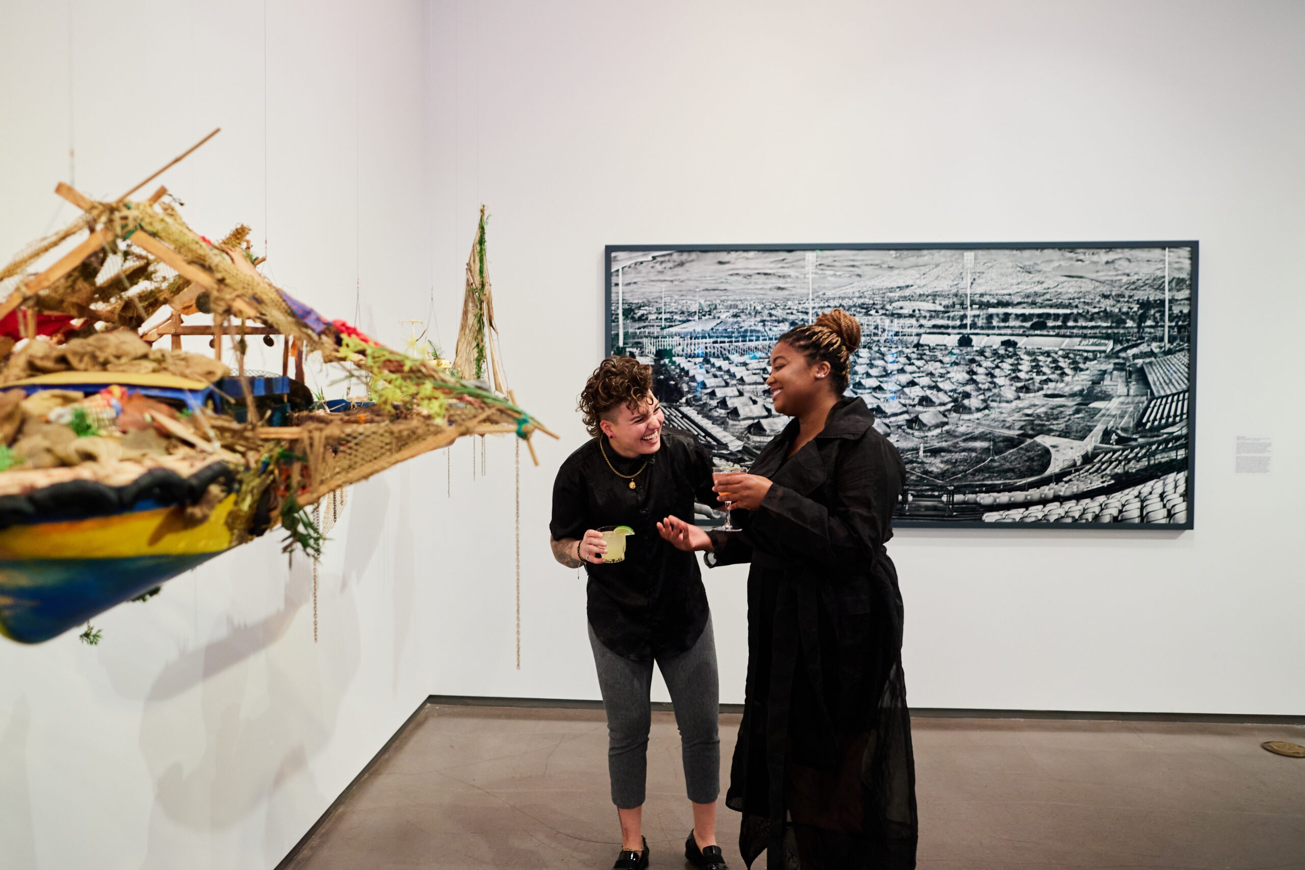 two people talking and laughing in museum