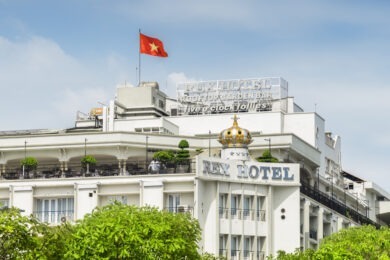 hotel topped by red flag with star in middle