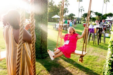 Neen James in a pink dress swinging