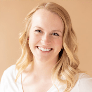 woman smiling, wearing white v-neck shirt