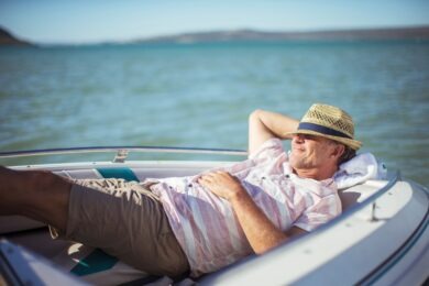 Older man relaxing in boat on water