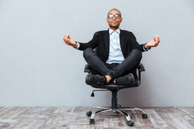 man sitting and meditating on office chair