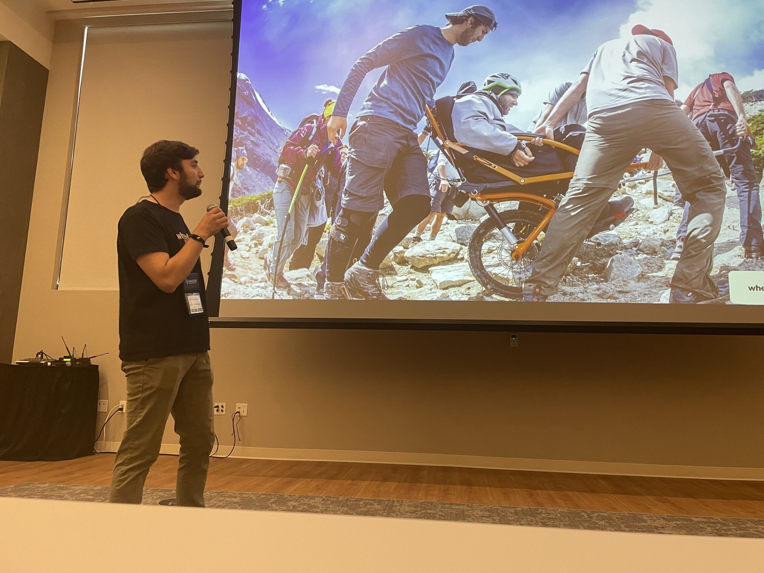 man speaking in front of group