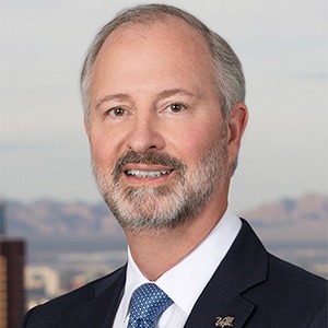 man smiling, wearing suit