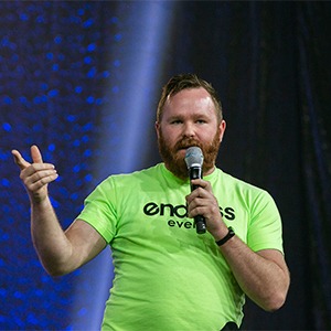 man in neon green shirt talking into microphone