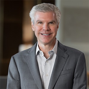 man wearing light grey dress shirt and dark grey coat