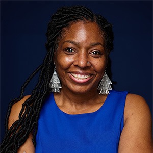 woman in blue sleeveless shirt smiling