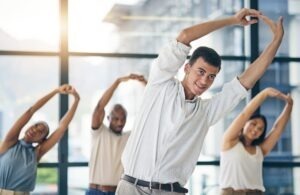 image of a business team stretching on a wellness break based on Accor survey