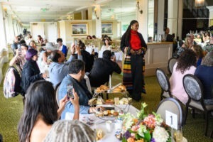 Oakland Style, High Tea and High Fashion Courtesy of Visit Oakland, model poses for guests at high tea event fashion show photo by KSJ Photography