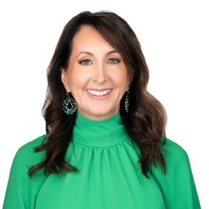 woman in green long sleeved shirt smiling