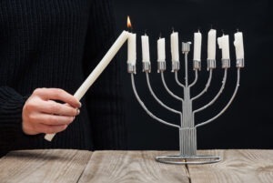 Partial View Of, Woman Lighting Candles On Menorah