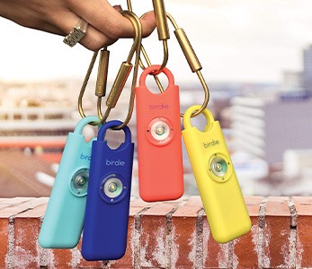 person holding four colorful keys
