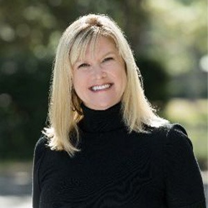 woman in black turtleneck sweater smiling