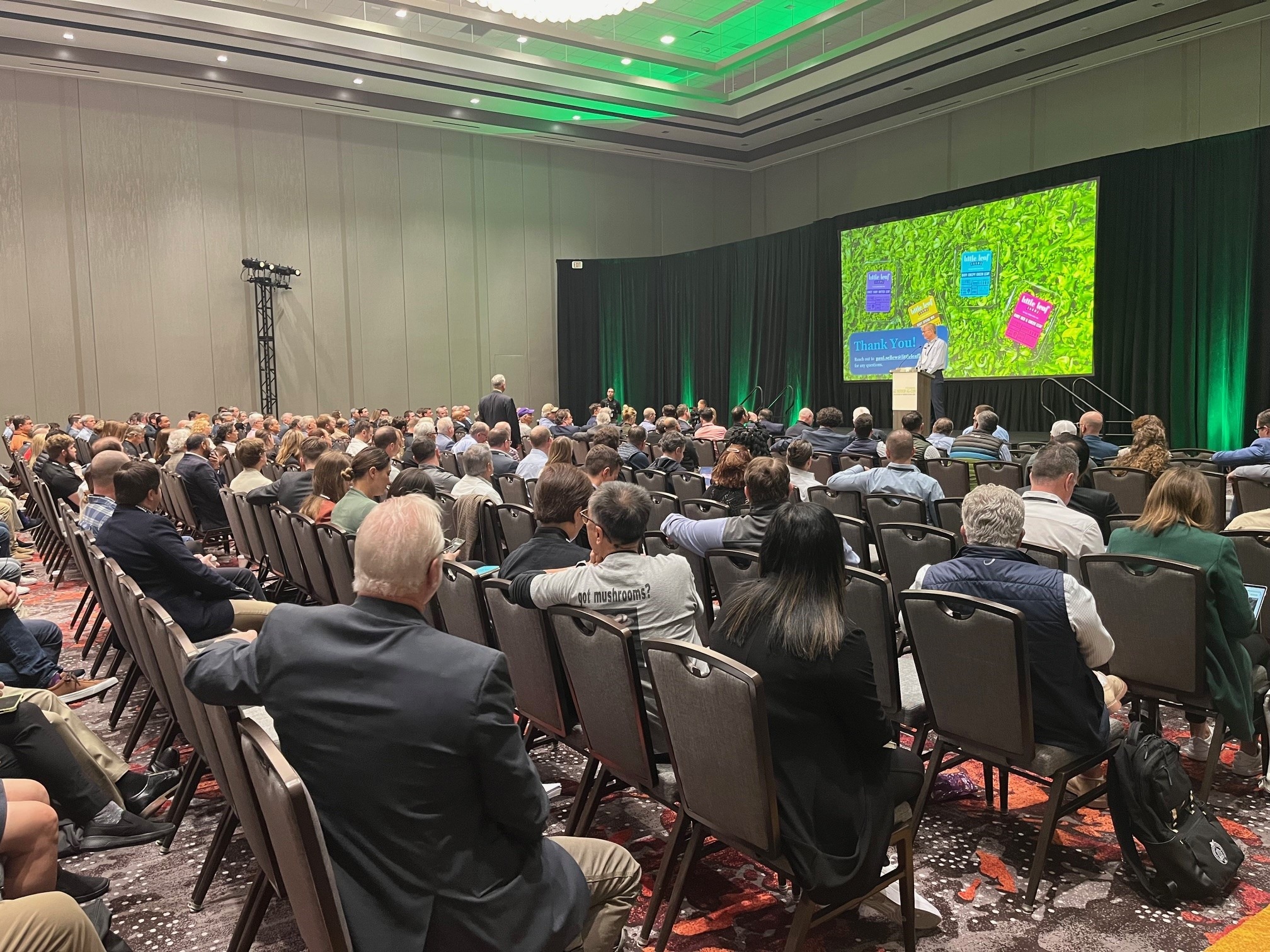 large group of people sitting in ballroom 