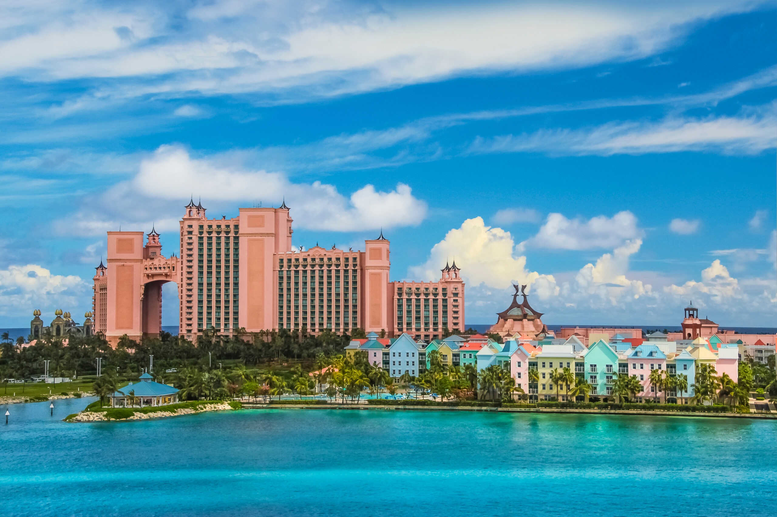 wide shot of ocean and large hotel in background