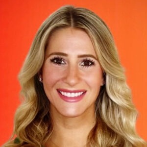 woman smiling on orange background