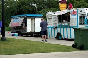man walking next to ice cream truck