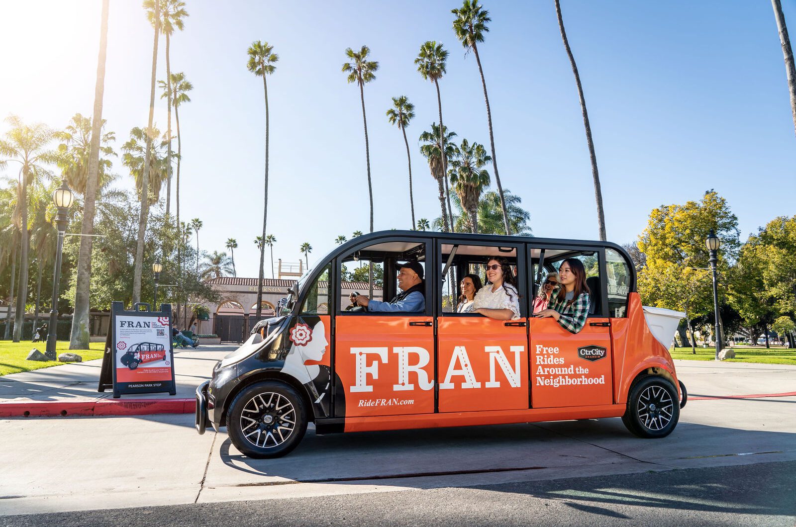 orange windowless bus driving on street