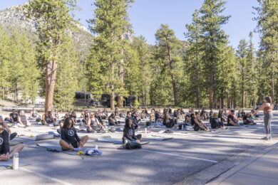 people sitting around in parking lot for yoga