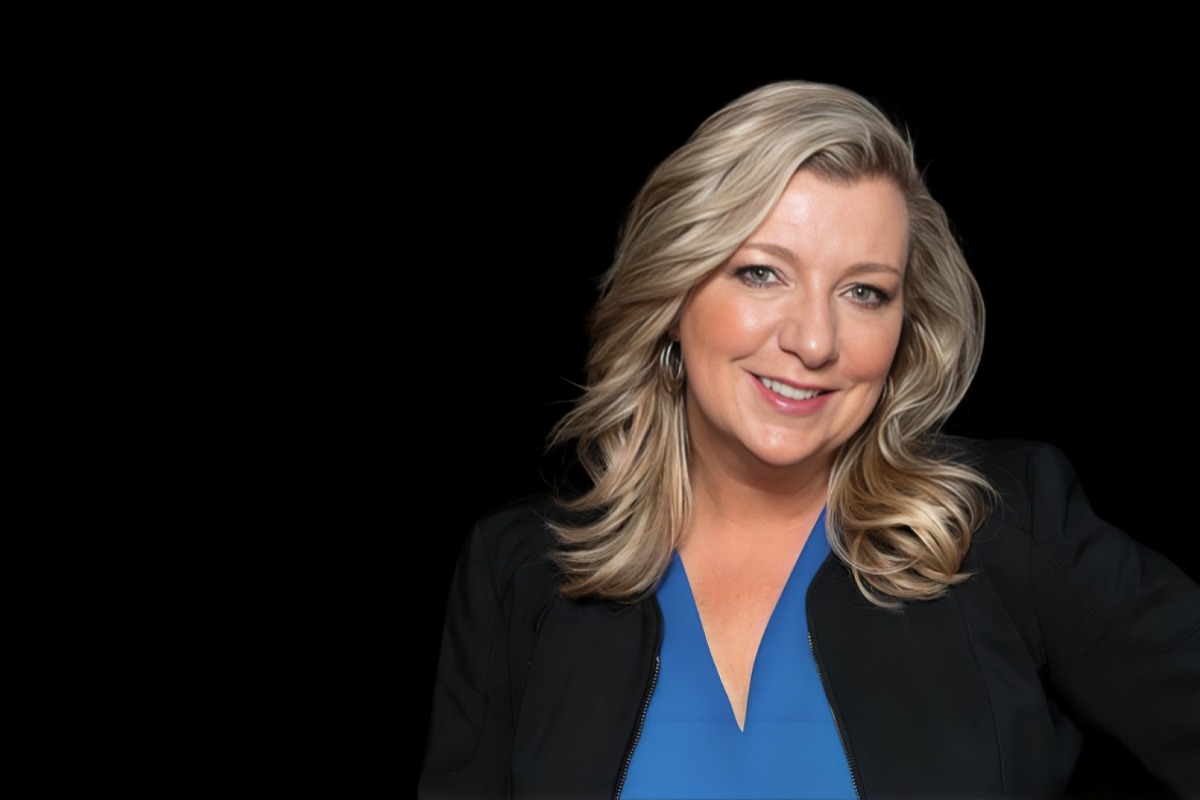 woman wearing blue shirt and black coat on black background