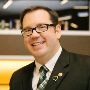 Kevin Molesworth wearing suit and smiling