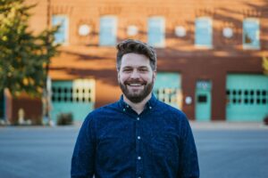 Kyle Scheele standing in front of building