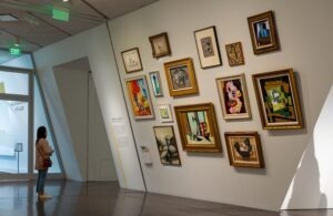 person standing in front of wall with pictures on it at Denver Art Museum