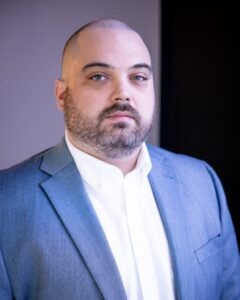 Thomas Whelan wearing blue sport coat and white shirt