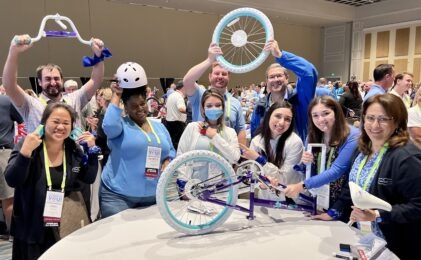 group of people assembling child's bike