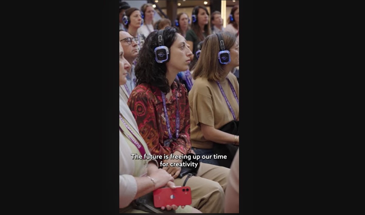 crowd sitting down and wearing headphones