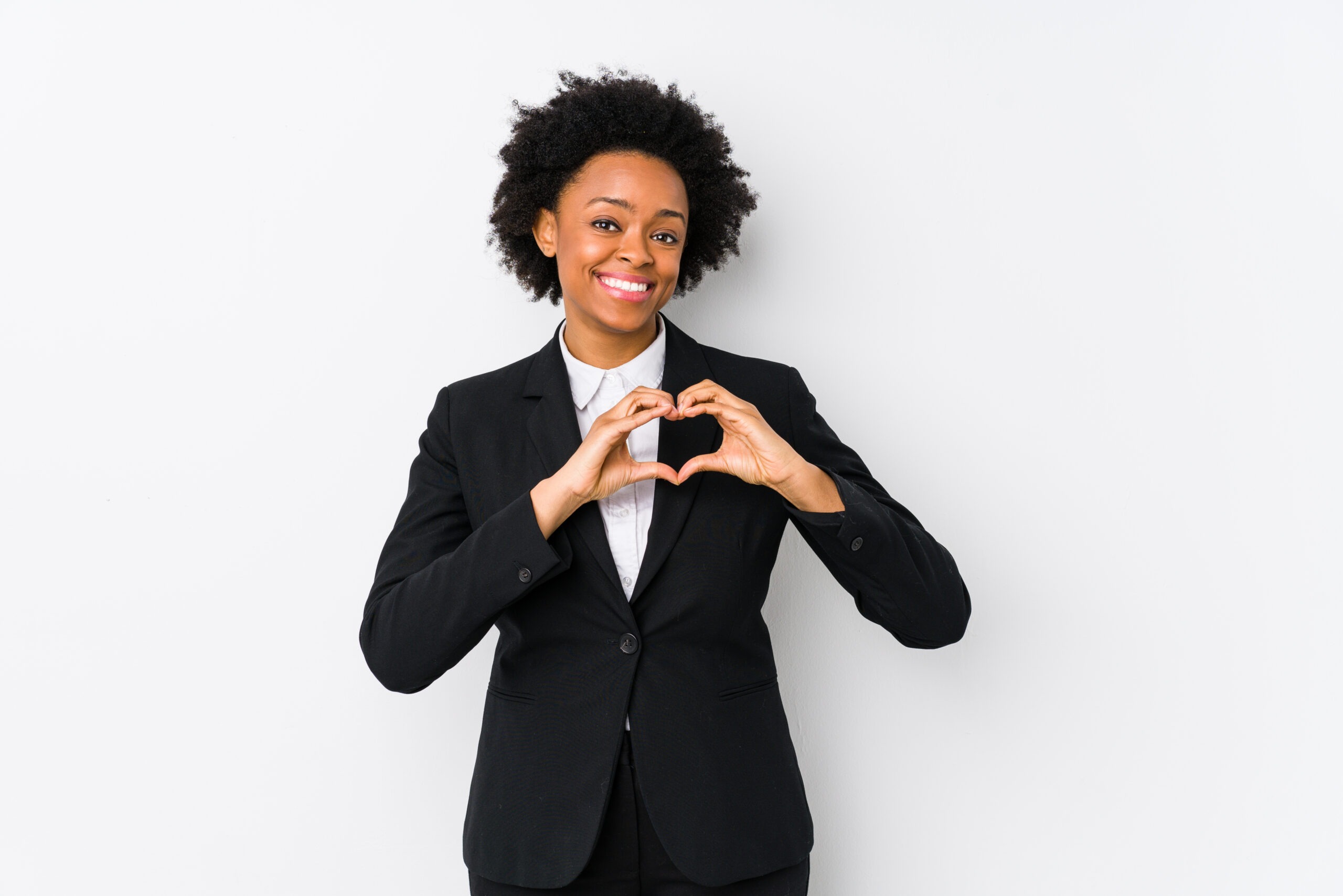 businesswoman making heart shape with hands